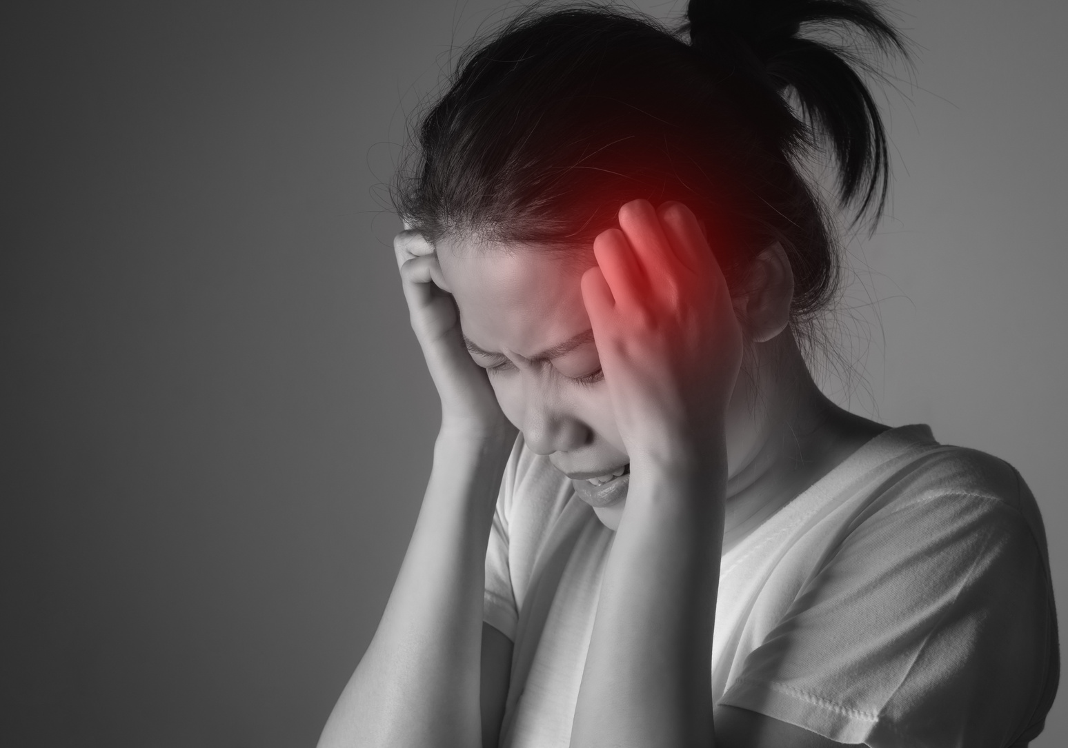 Young asian woman having a headache